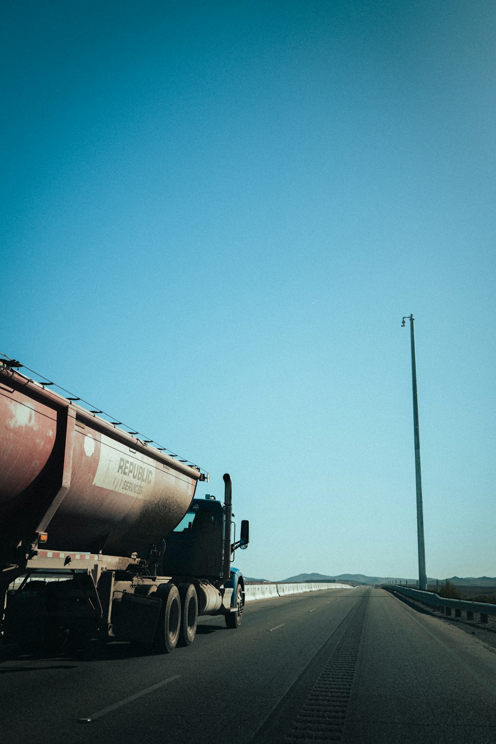 a large tanker truck driving down a highway