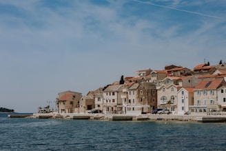 A picturesque coastal view of a sunny Portuguese village with charming houses and blue skies.