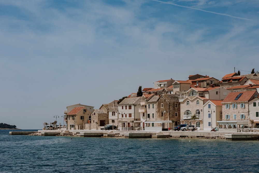 a row of houses next to a body of water