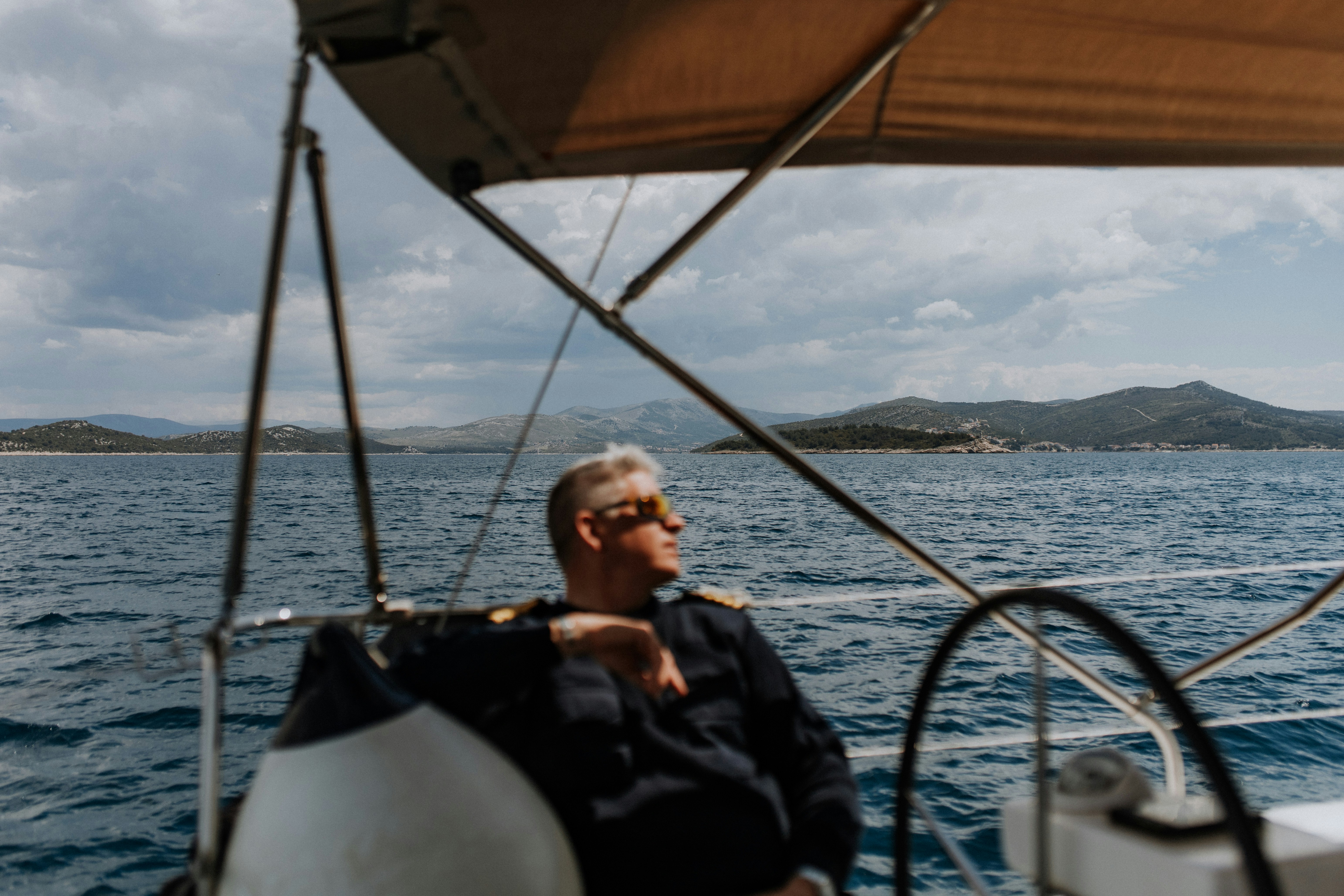 a man sitting on a boat in the ocean