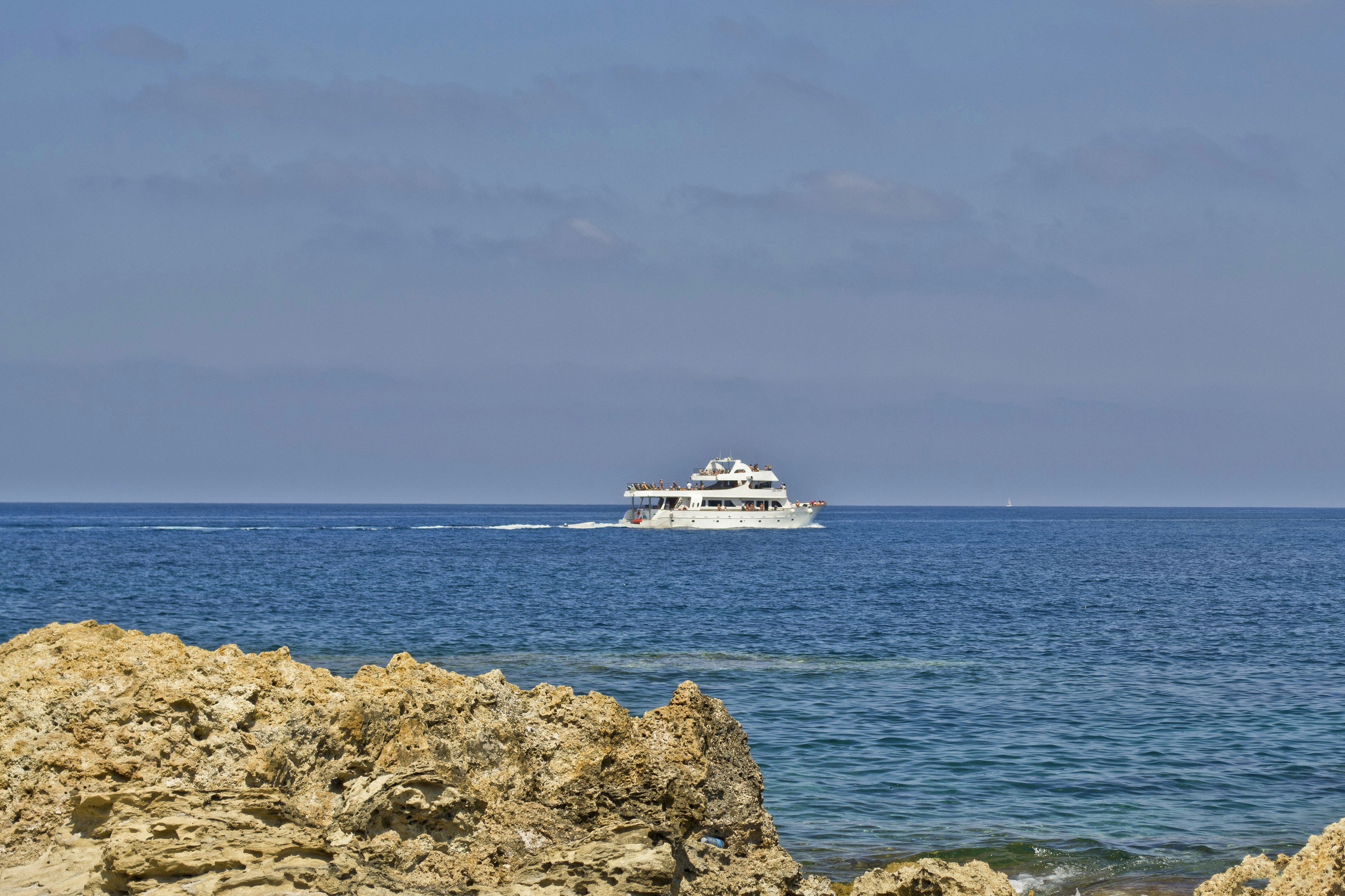a boat is out in the ocean on a sunny day