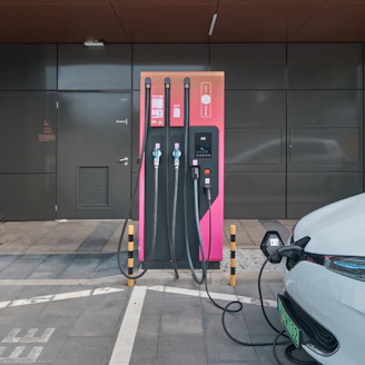 Professional electrician installing an EV charger on a modern Sydney home wall.