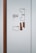 A wall features a minimalist directory map with the text 'Centrum Południe'. The map consists of outlined shapes representing different sections and floors, each labeled accordingly. The color scheme mainly includes shades of brown and light blue. The wall also shows a vertical brown panel on the left side.