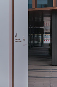 Side-by-side images showing a commercial building's entrance before and after pressure washing.