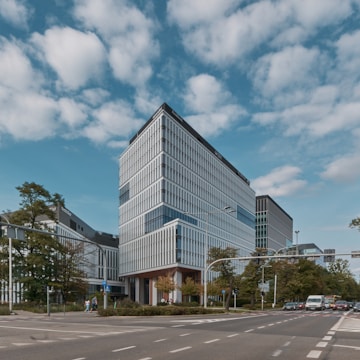 Commercial office building with glass facade and busy street view.