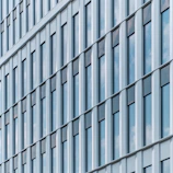 Elegant grid of modern windows on a sleek building facade, emphasizing clean lines.