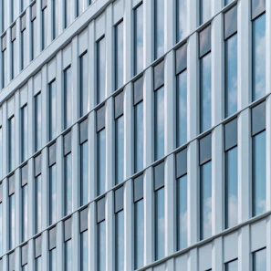 Elegant grid of modern windows on a sleek building facade, emphasizing clean lines.