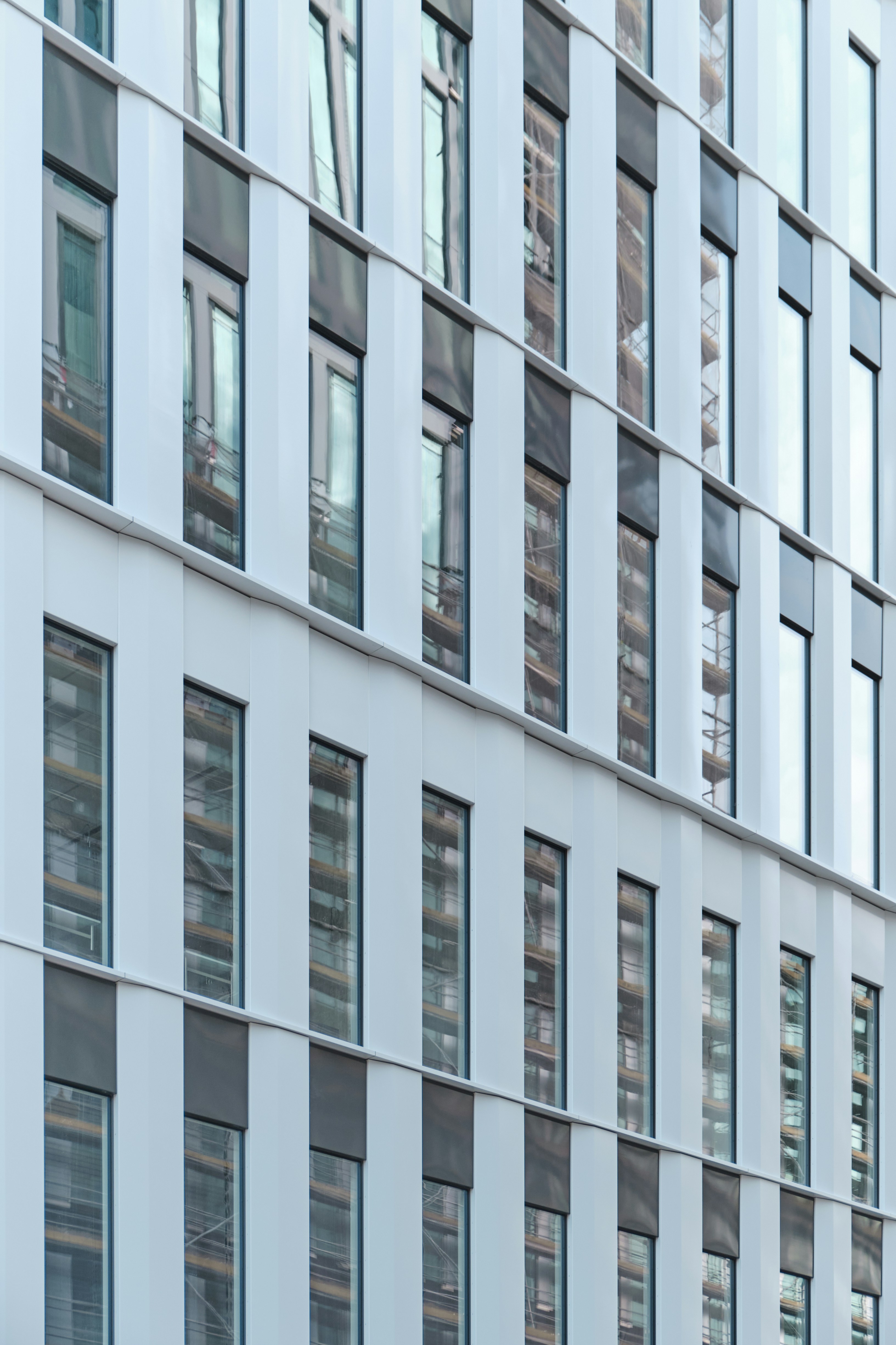 a tall building with lots of windows next to a street