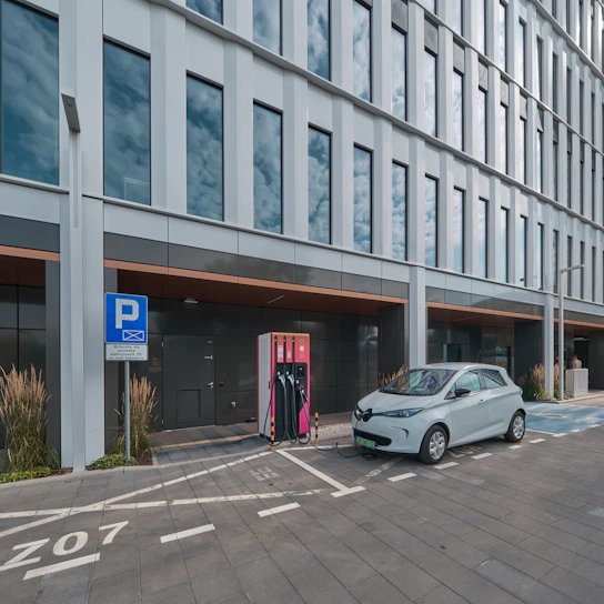 Electric vehicle charging station installed in a modern condominium parking lot.