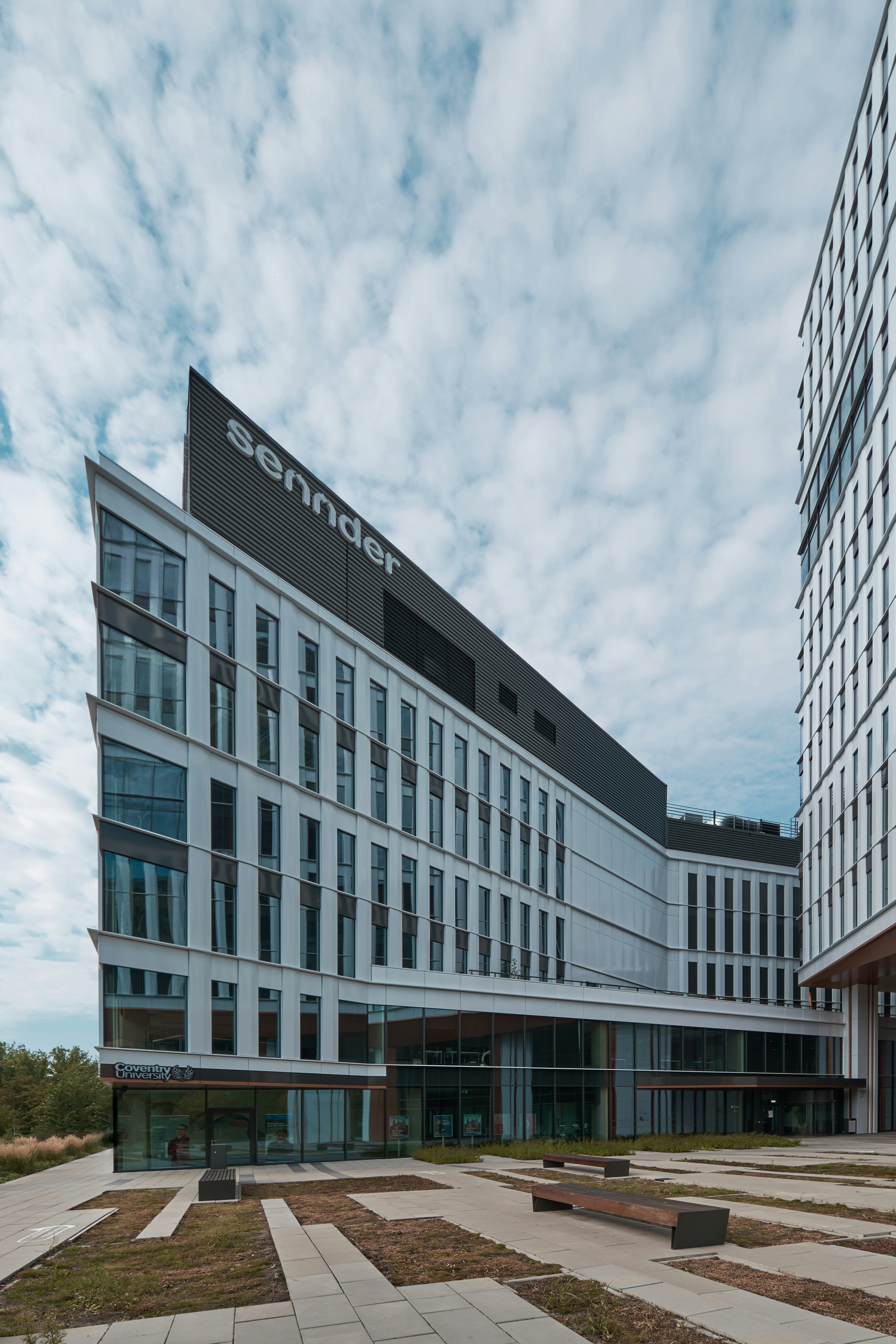 a large white building sitting next to a tall building