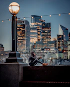 A scenic American city skyline with a person using a smartphone outdoors.