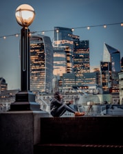 Close-up of a marketing specialist analyzing conversion statistics on a tablet with city lights in the background.