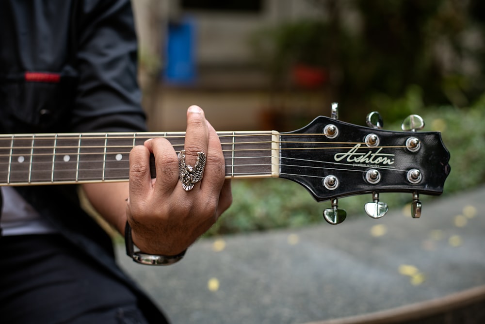 a close up of a person playing a guitar