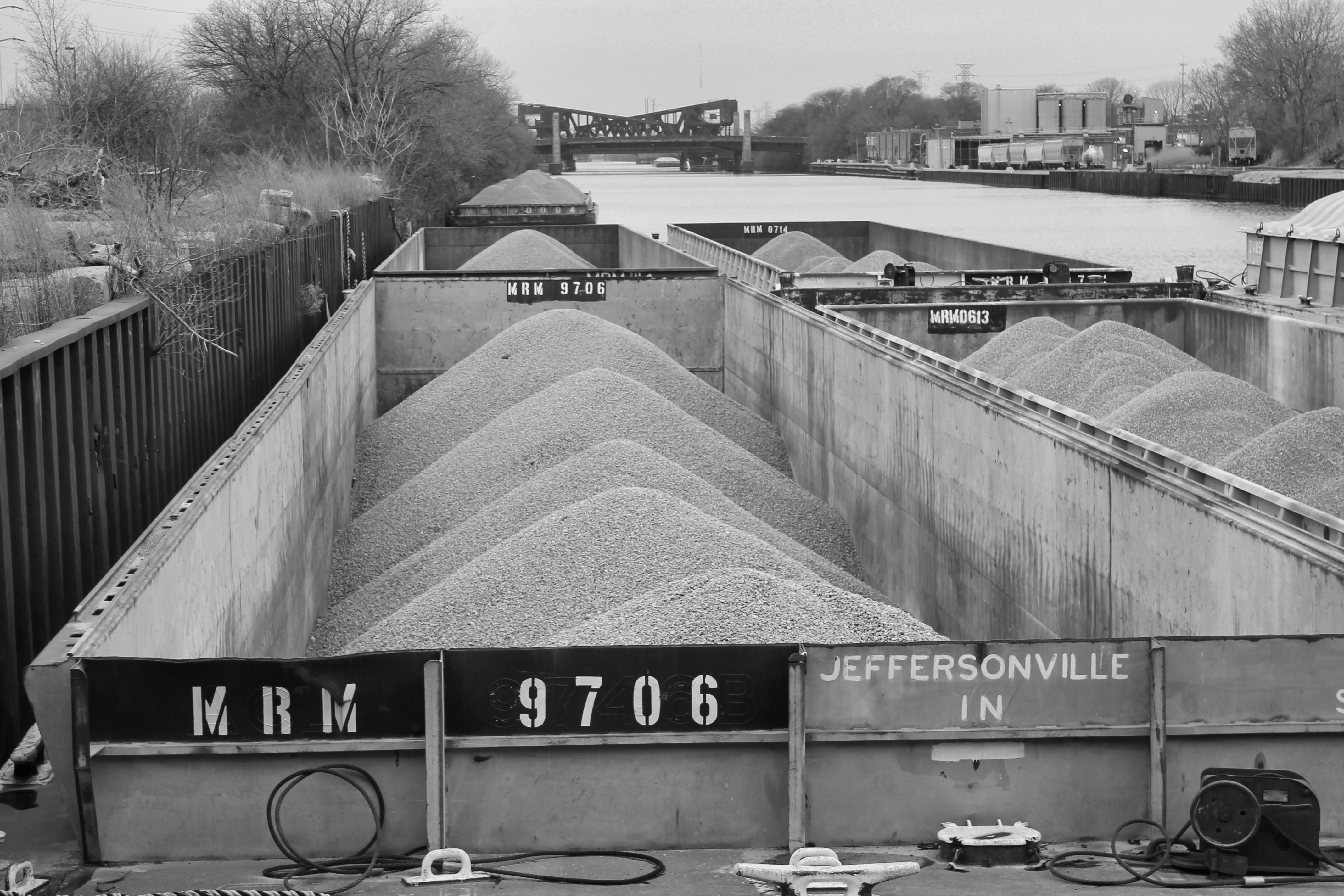 a black and white photo of a conveyor belt (Photo by Josh Sonnenberg on Unsplash)