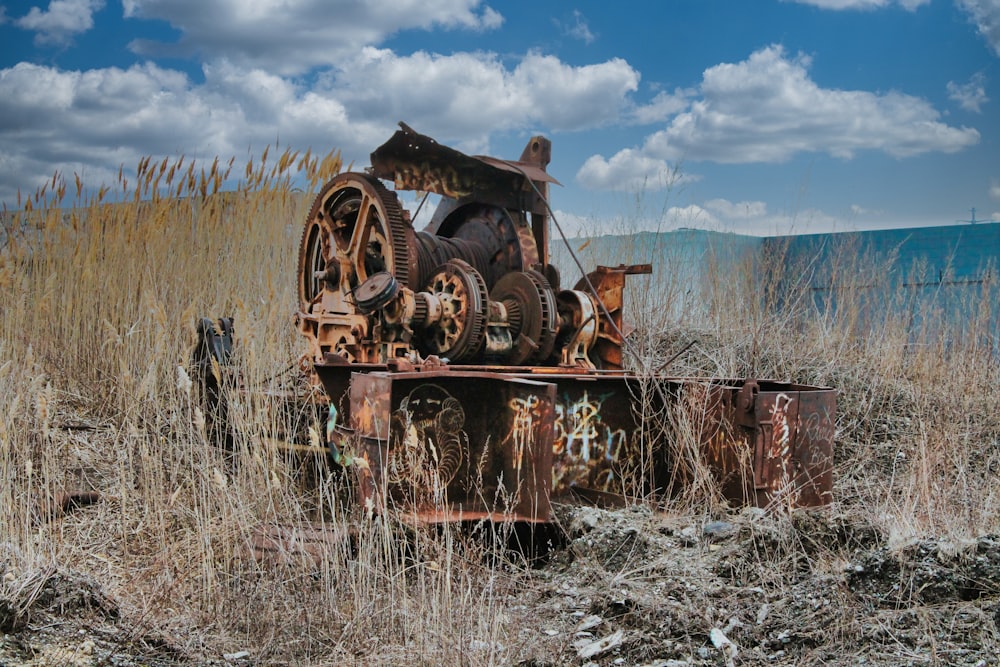 a rusted out truck sitting in a field