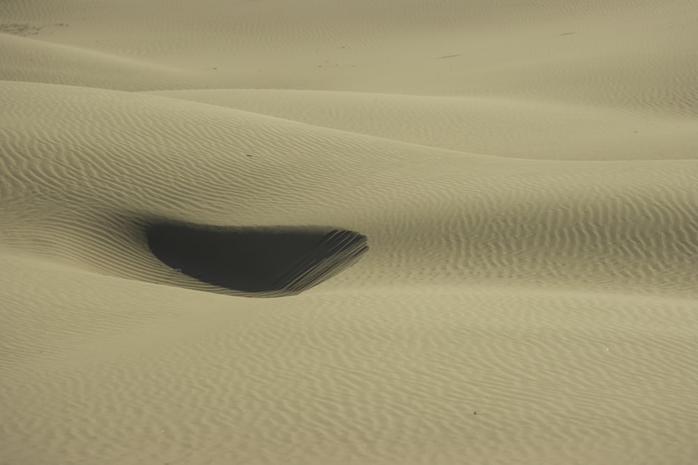 a rock in the middle of a desert