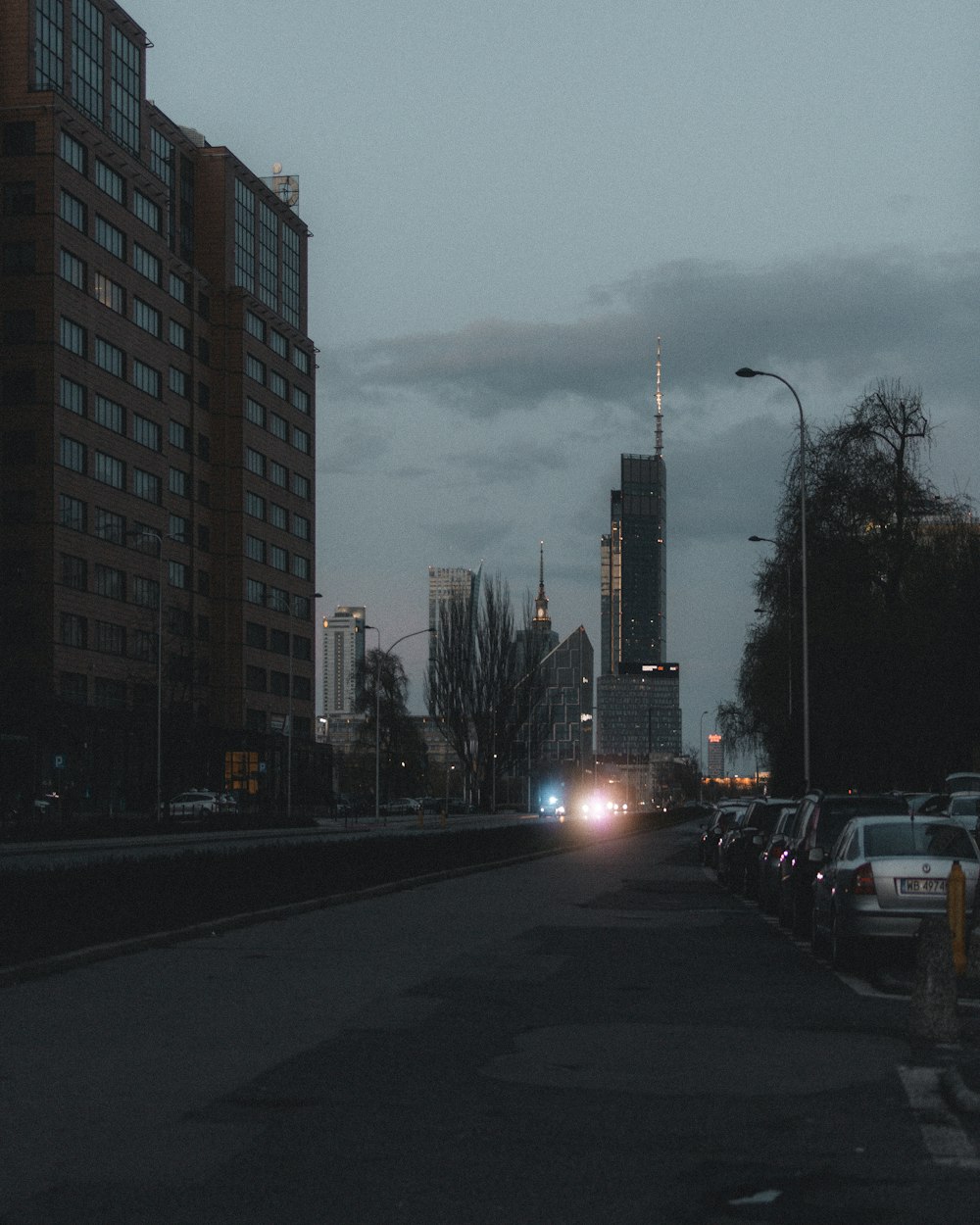 a city street with cars parked on the side of it