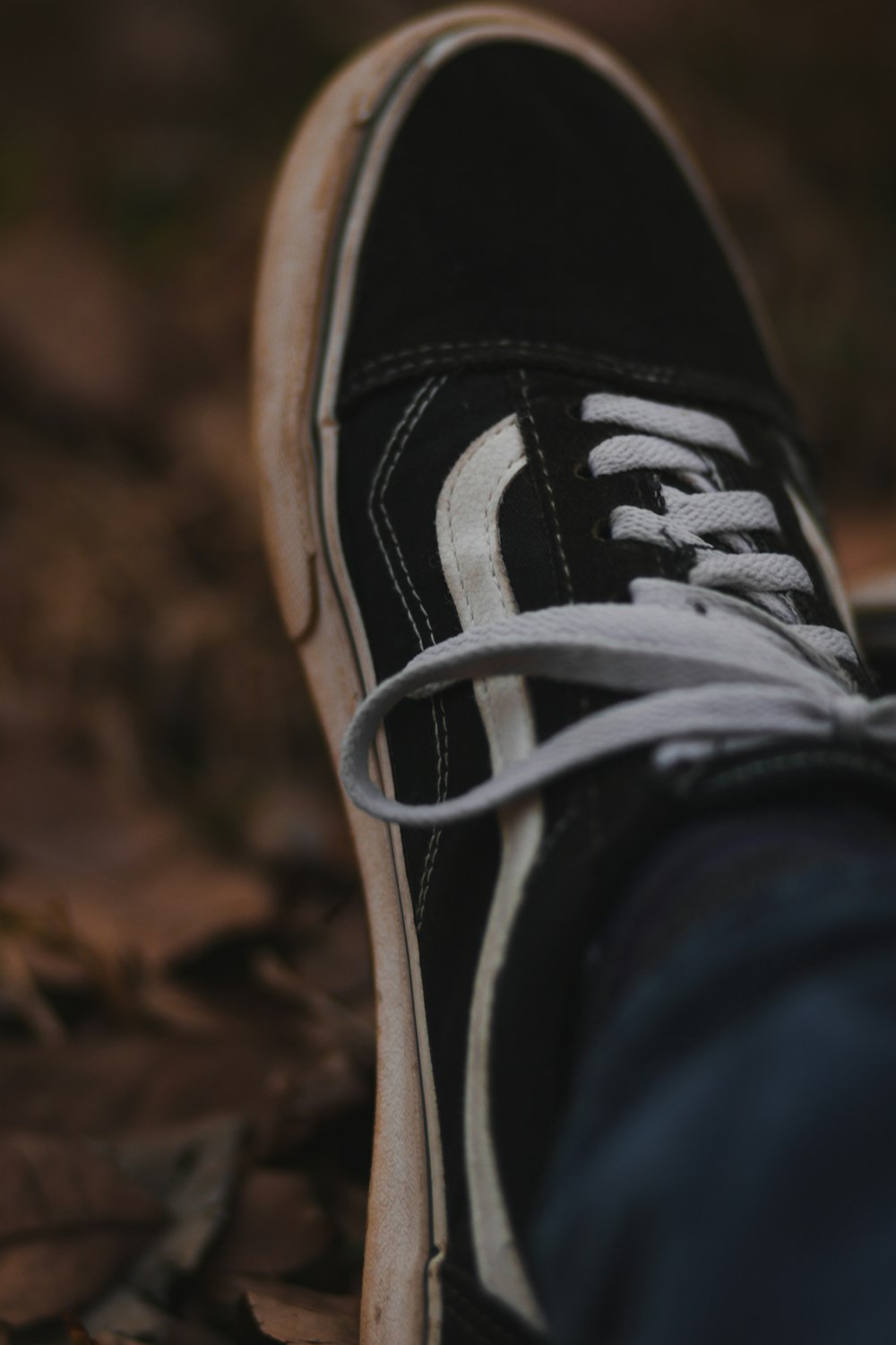 a person's black and white shoes with white laces