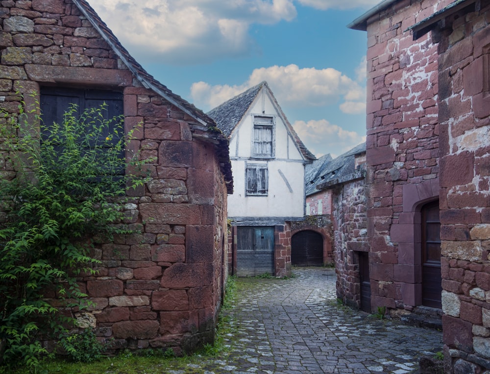 a cobblestone street lined with old brick buildings