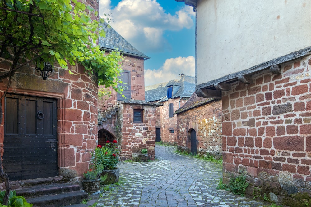 a cobblestone street lined with old brick buildings