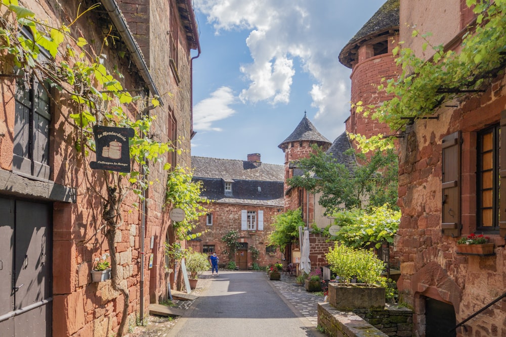 a narrow street with a brick building on the other side