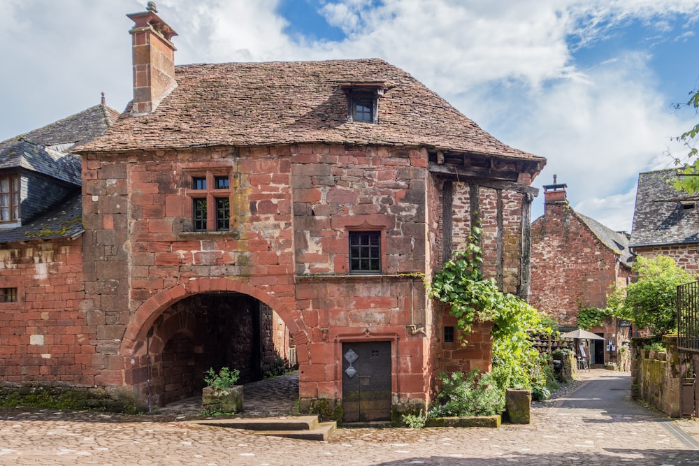 an old brick building with a stone walkway leading to it