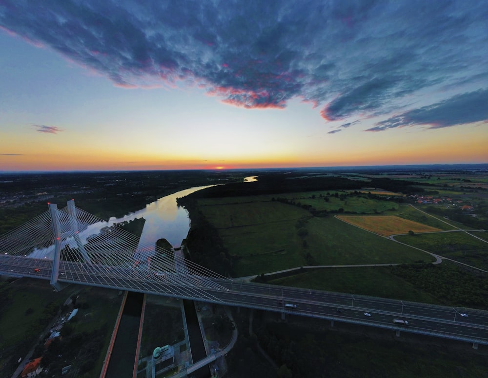 an aerial view of a bridge at sunset