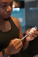 a person holding an insulin injection