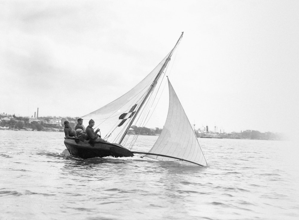 a black and white photo of a sailboat in the water