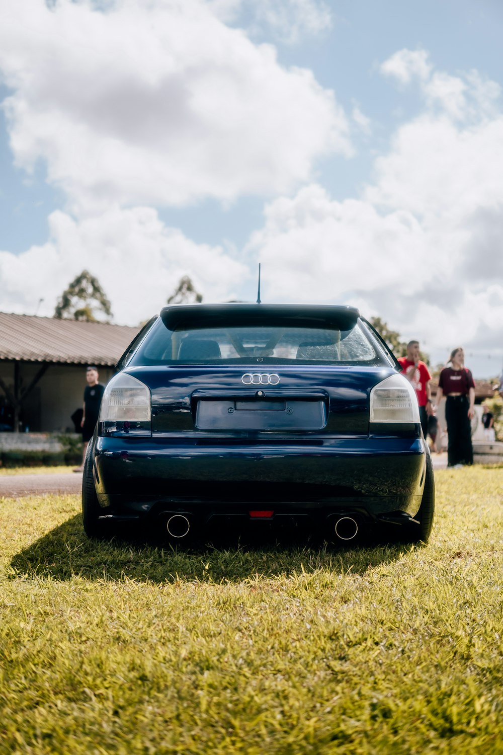 A blue car parked on top of a lush green field photo – Free Brasil Image on  Unsplash
