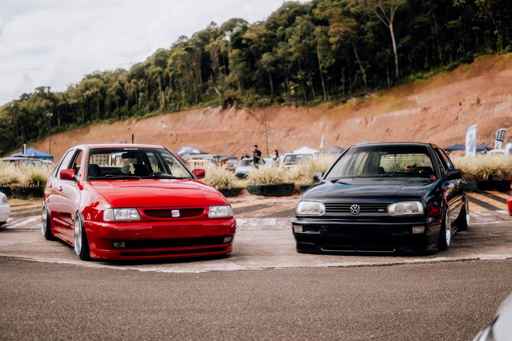 a couple of cars parked next to each other in a parking lot