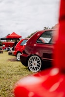 a row of red cars parked next to each other