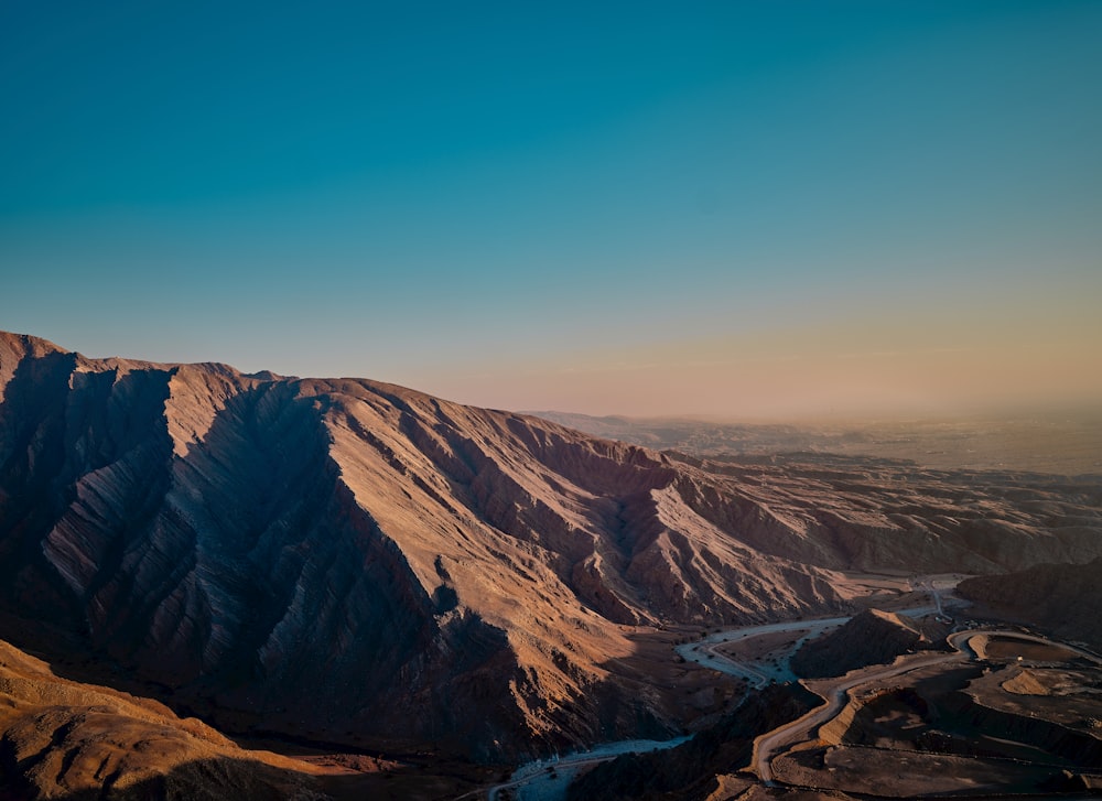 an aerial view of a mountain range with a river running through it