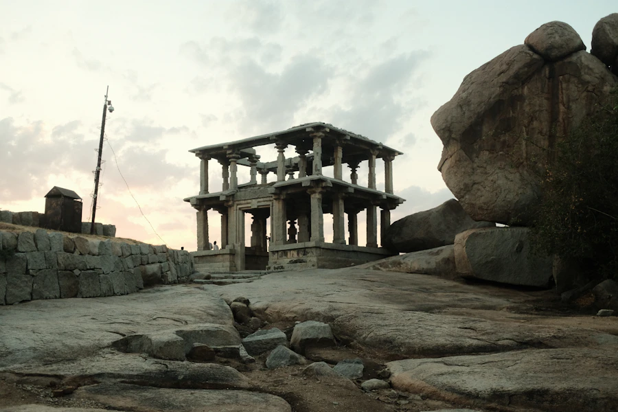 A stone structure sitting atop a rocky hillside, evoking a foundation