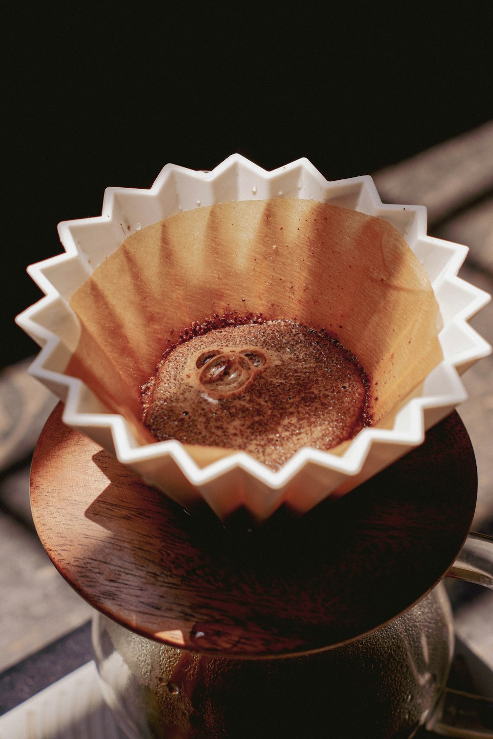 a coffee pot filled with liquid on top of a wooden table