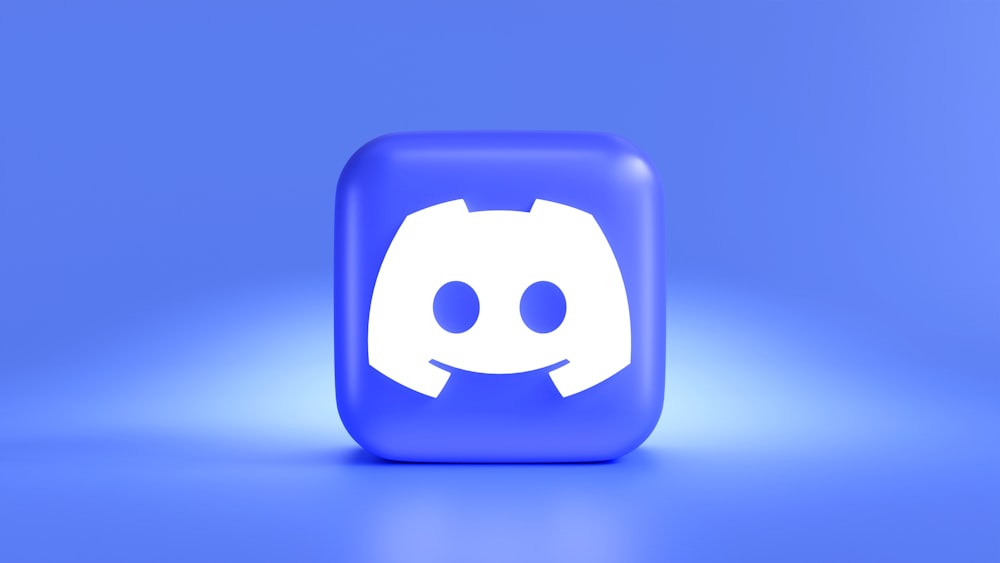 a square button with a smiley face on a blue background