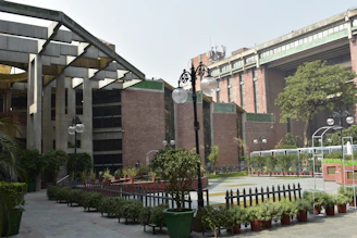 a building with a lot of potted plants in front of it