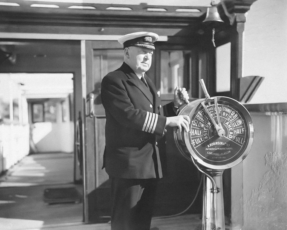 a man in uniform standing next to a clock
