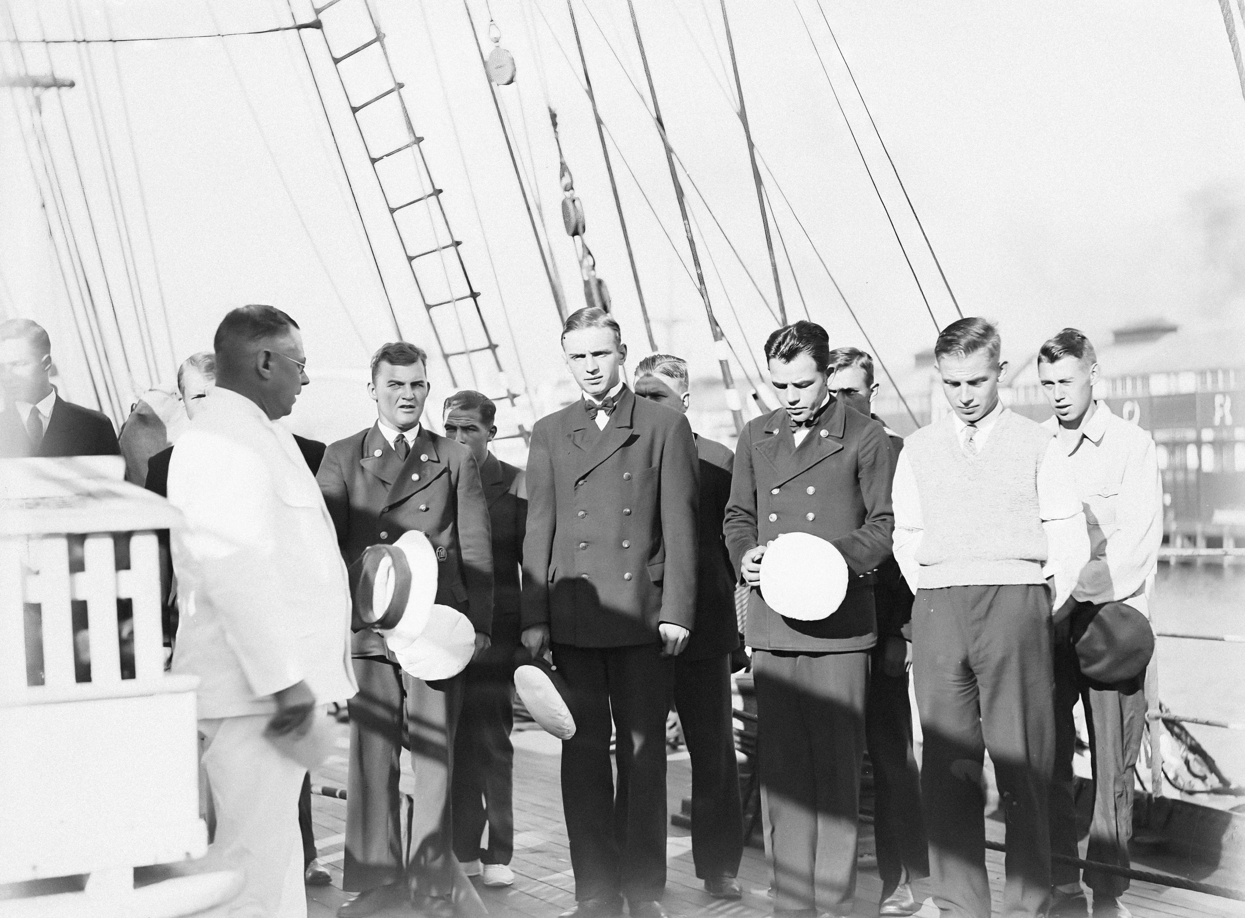 a group of men standing next to each other on a boat
