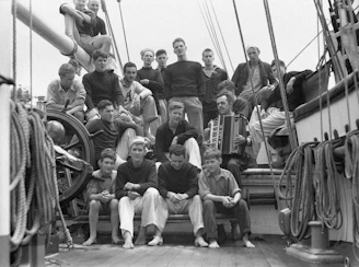 A group of seniors clapping and singing along during a sea shanties performance.