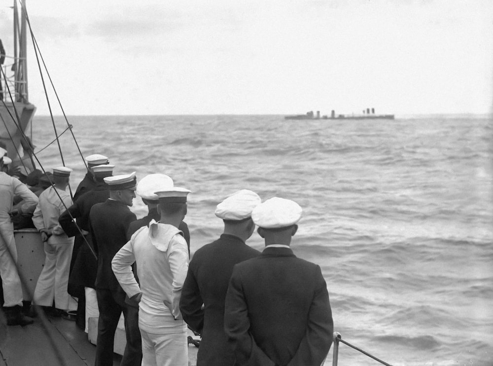 a group of men standing on top of a boat