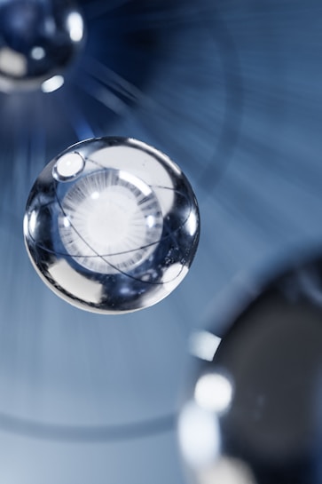 Metallic spheres hover in a blurred, abstract background creating a futuristic and sleek appearance.