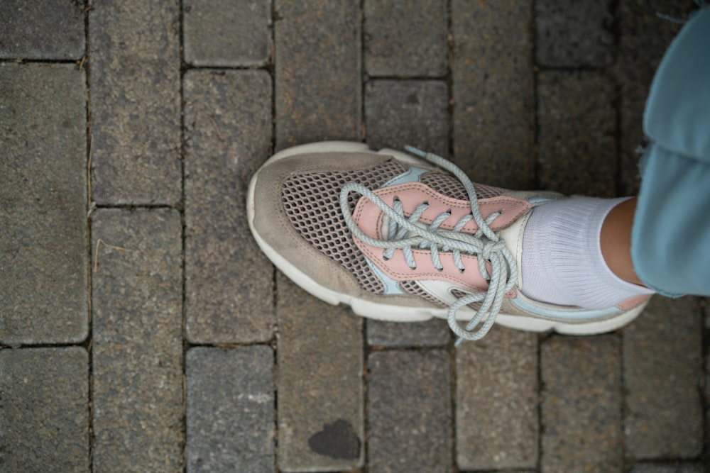 a person standing on a brick walkway with their shoes on