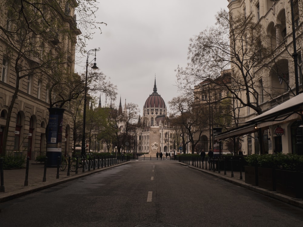 an empty street with a church in the background