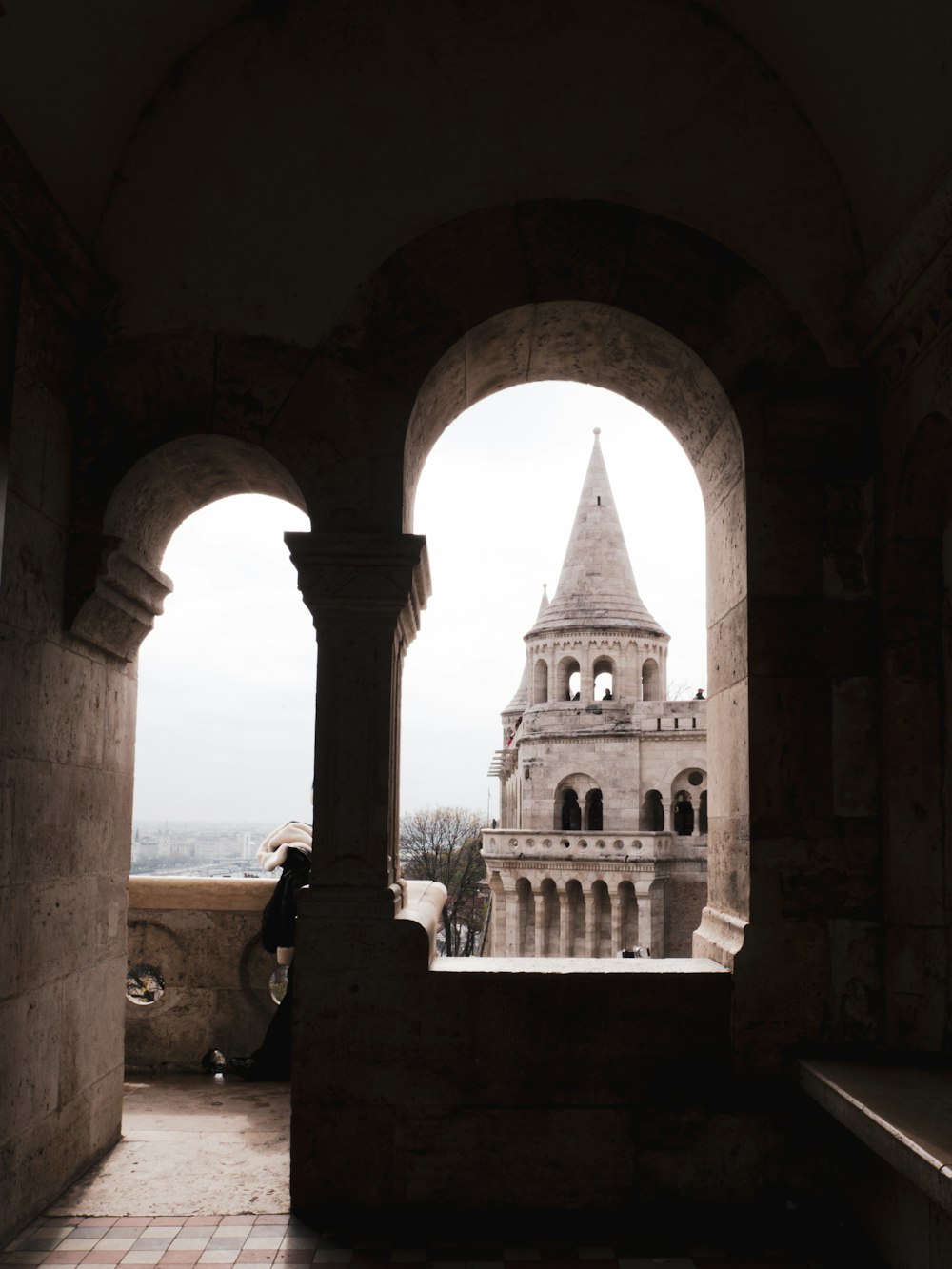 a view of a clock tower through an archway