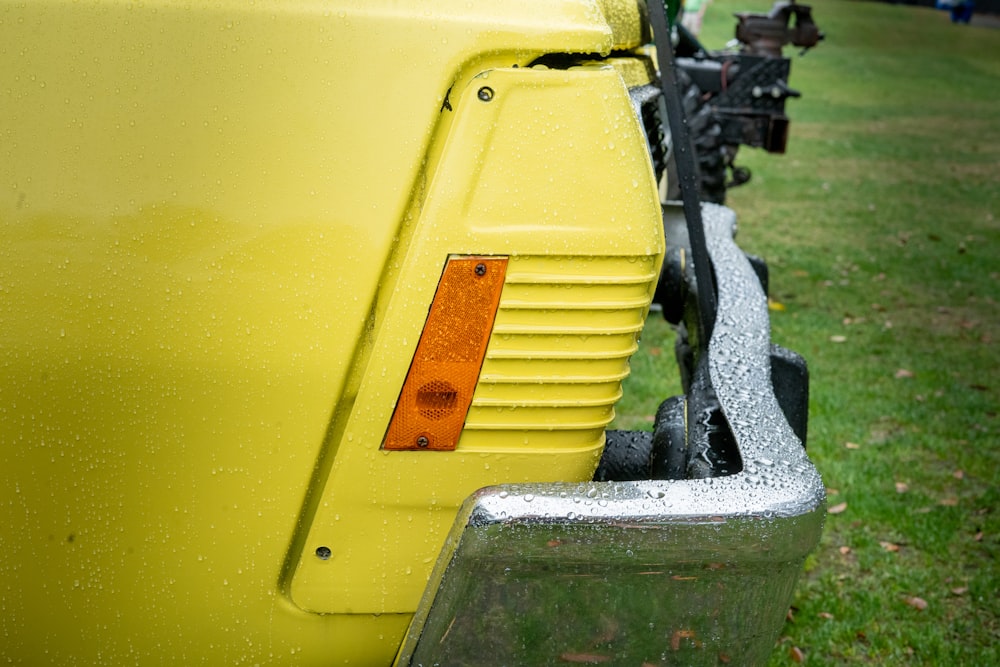 a close up of the tail lights of a yellow truck