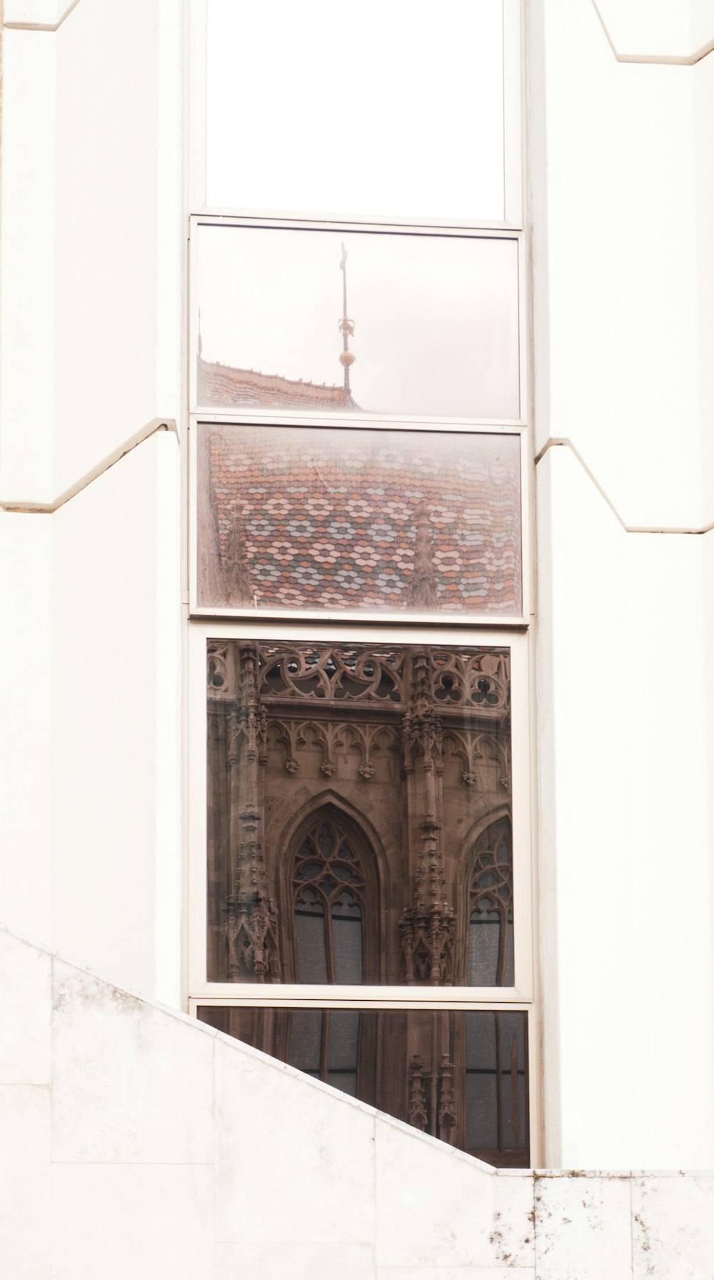 a reflection of a building in a window