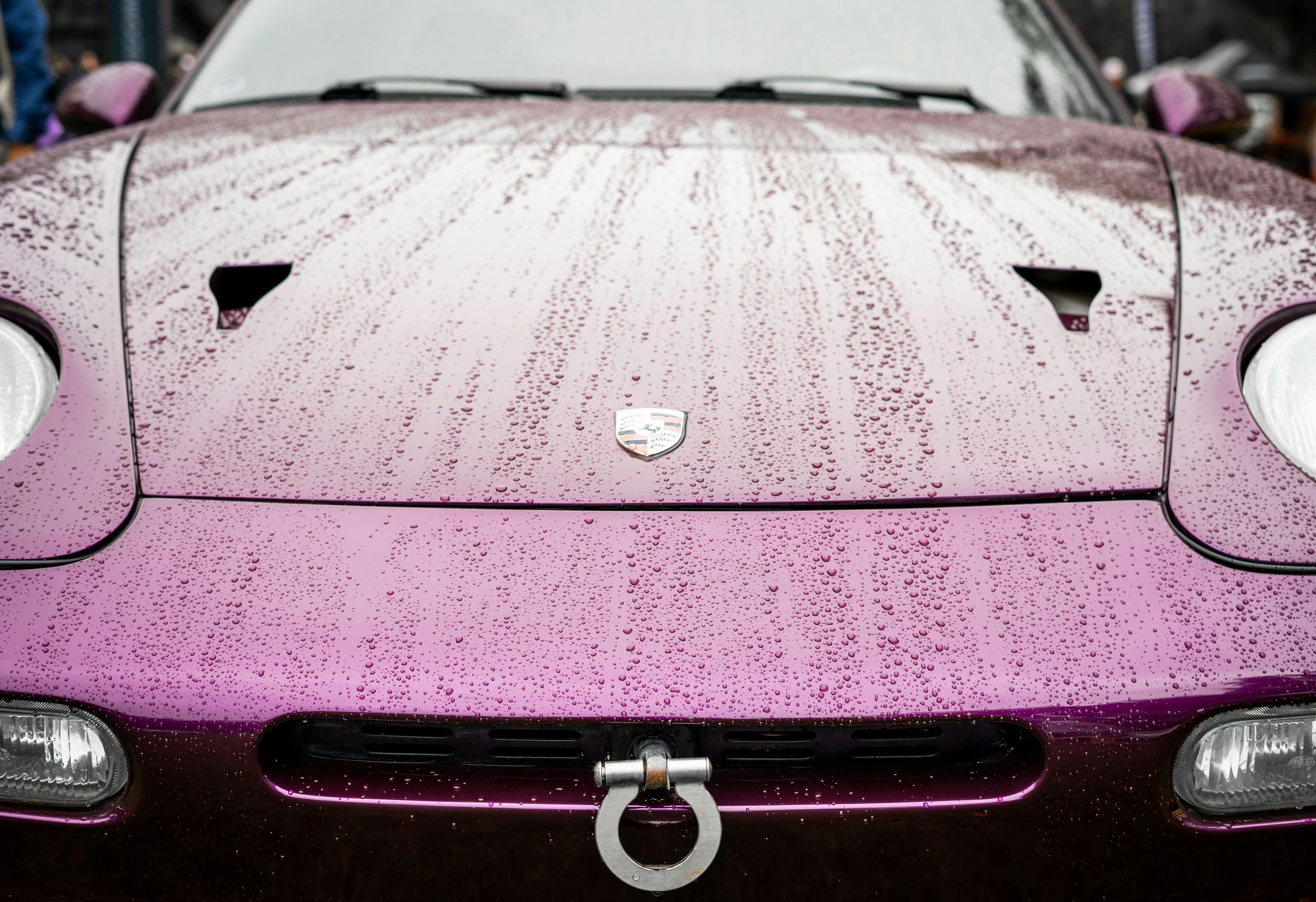 a purple sports car parked in a parking lot, 