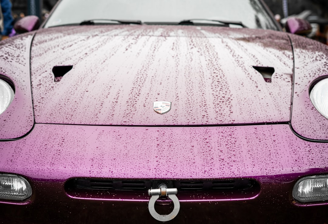 a purple sports car parked in a parking lot,