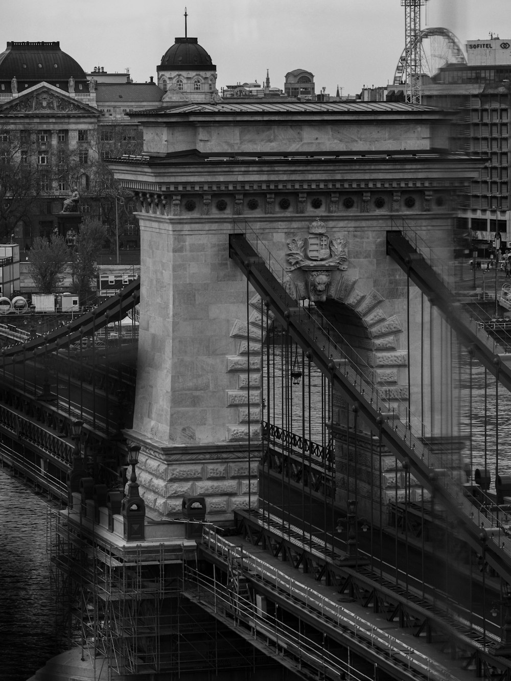 a black and white photo of a bridge with scaffolding